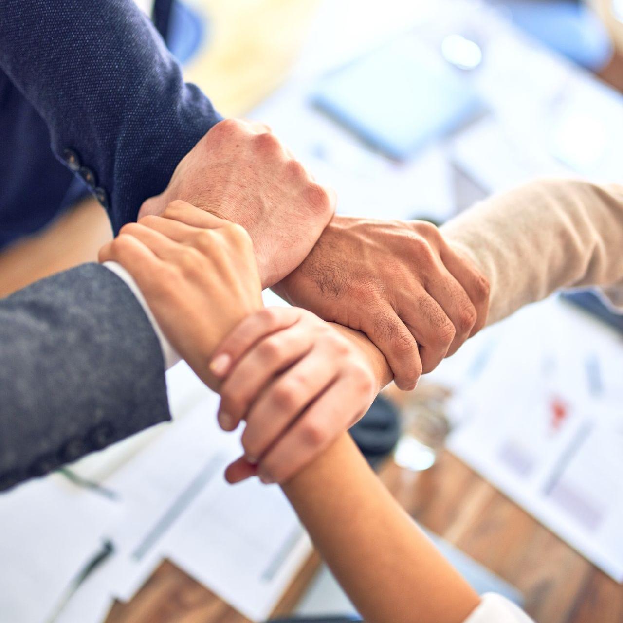 person in black long sleeve shirt holding persons hand